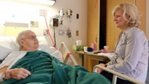 Patient in hospital bed with visitor