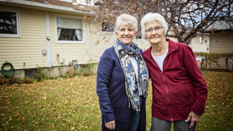 Elderly mother with daughter in yard
