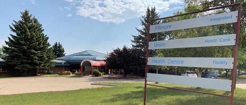 A sign reads Fillmore Health Centre on the right, with the Fillmore Health Centre in the distance on the left.