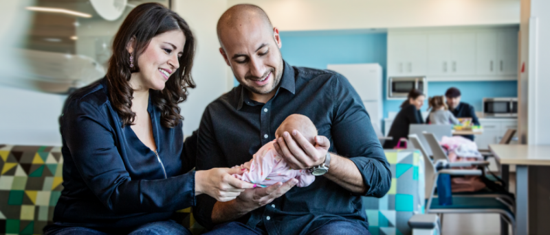 Mother and Father holding newborn child