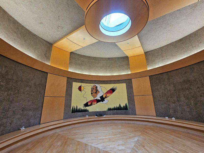 Circular space at Regina General Hospital with Indigenous mural on the wall and sunlight on the ceiling